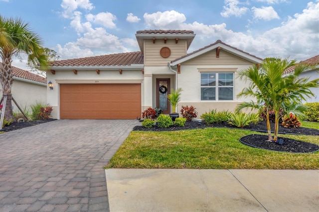 mediterranean / spanish-style home with a front yard and a garage