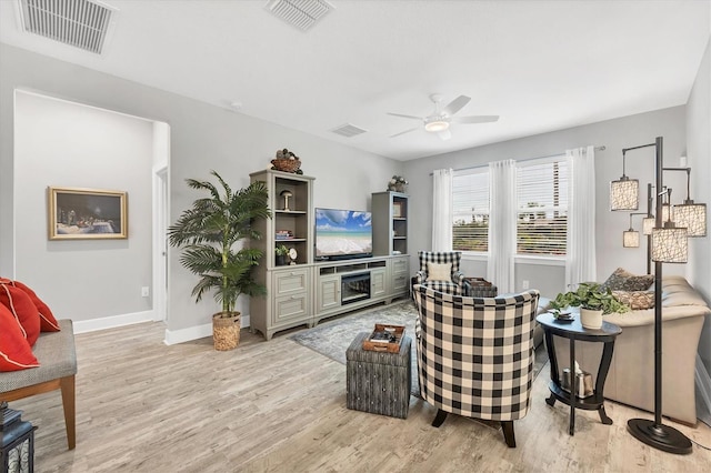 living room featuring ceiling fan and light hardwood / wood-style floors