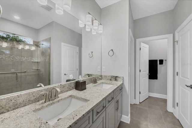 bathroom featuring an enclosed shower, vanity, and tile patterned flooring