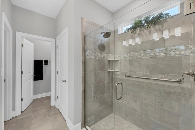 bathroom featuring a shower with door and tile patterned flooring