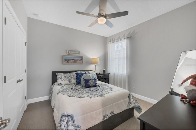 carpeted bedroom featuring ceiling fan and a closet