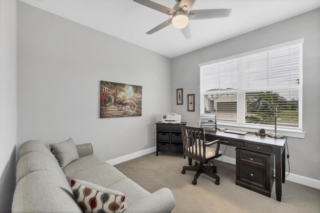 office area featuring light carpet and ceiling fan