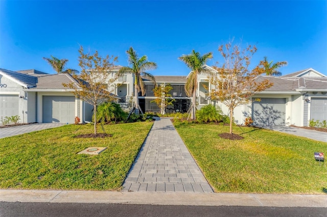 ranch-style home featuring a front lawn and a garage