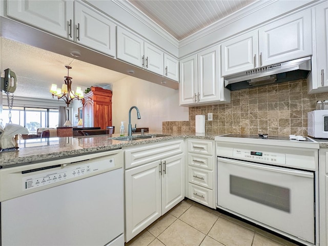 kitchen featuring white appliances, sink, light tile patterned floors, a notable chandelier, and white cabinetry