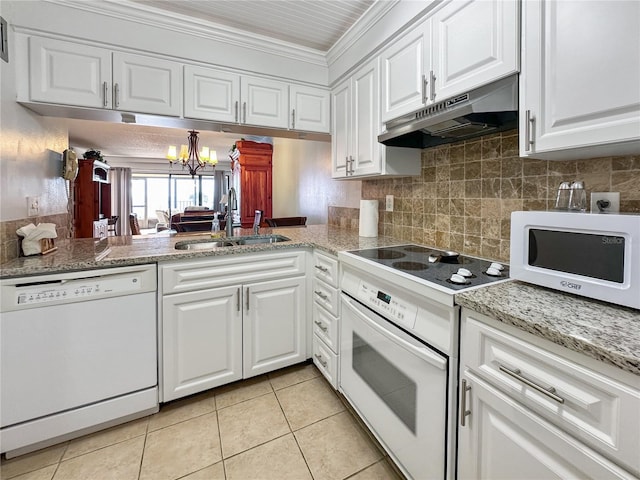 kitchen with sink, an inviting chandelier, white appliances, white cabinets, and ornamental molding