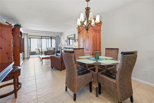 dining area featuring light tile patterned flooring, a chandelier, and a textured ceiling