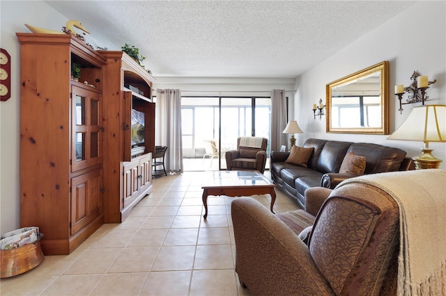 tiled living room featuring a textured ceiling