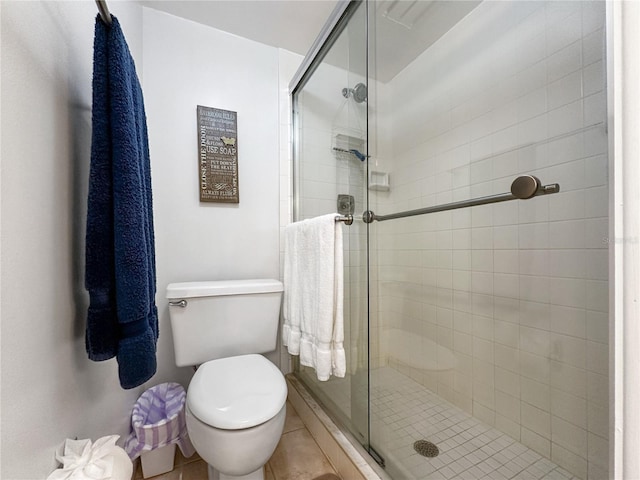 bathroom with tile patterned flooring, toilet, and walk in shower