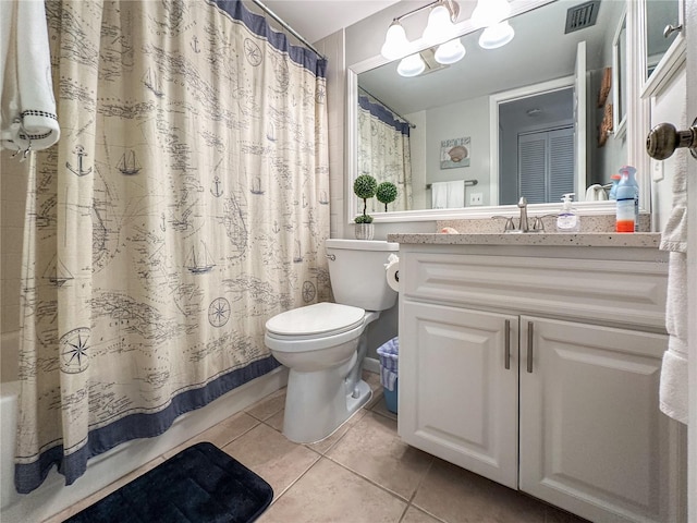 bathroom with tile patterned flooring, vanity, and toilet