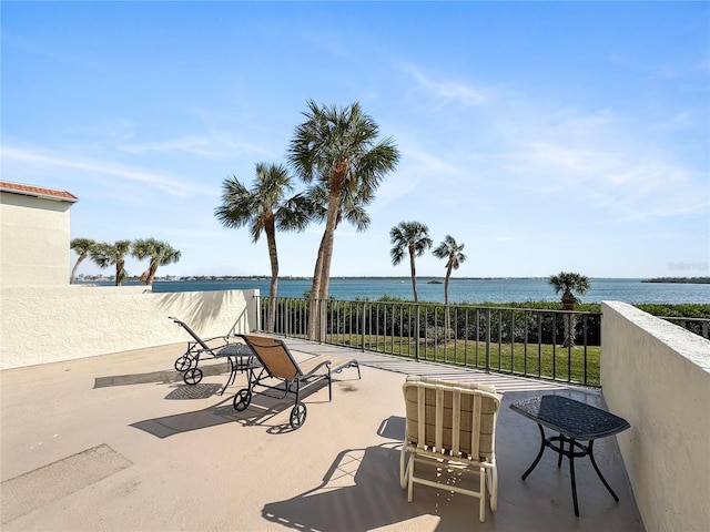 view of patio with a water view