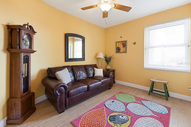 living room featuring ceiling fan, light hardwood / wood-style floors, and a wealth of natural light