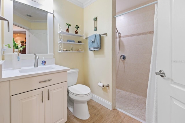 bathroom with a shower with curtain, crown molding, wood-type flooring, toilet, and vanity