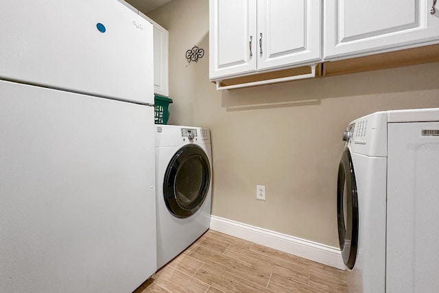 clothes washing area featuring cabinets