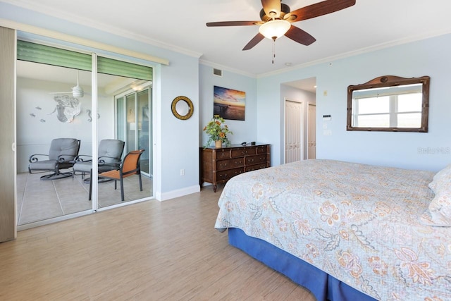 bedroom featuring multiple closets, ceiling fan, light wood-type flooring, and ornamental molding