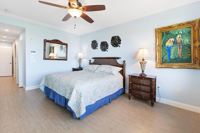 bedroom featuring ceiling fan, crown molding, and hardwood / wood-style floors