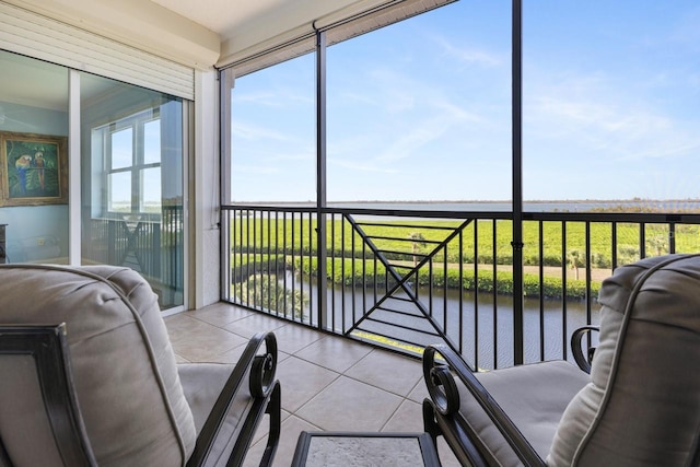 sunroom / solarium with a water view