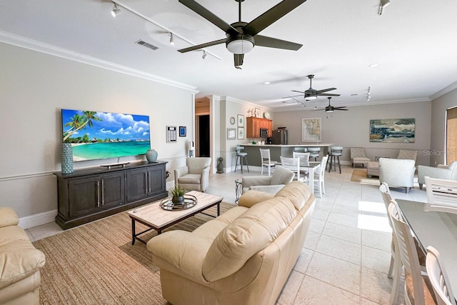 tiled living room with rail lighting and ornamental molding