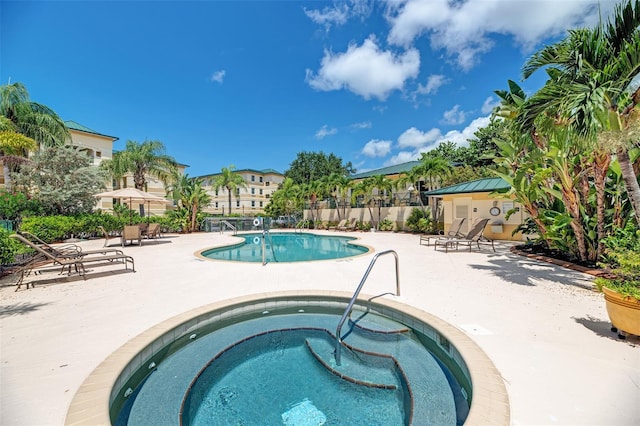 view of pool featuring a patio and a hot tub