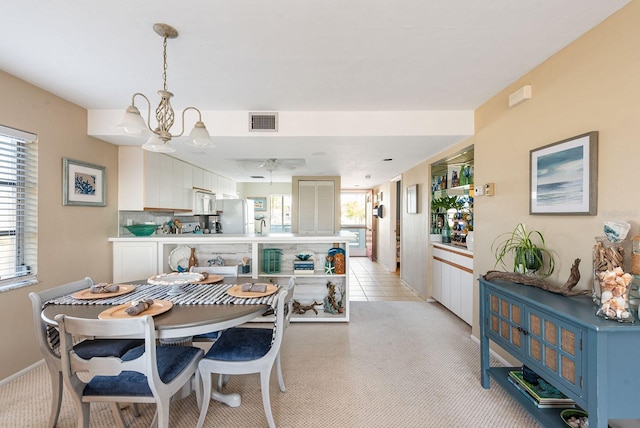 tiled dining area with a notable chandelier