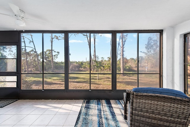 unfurnished sunroom with ceiling fan