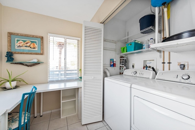 clothes washing area featuring washing machine and dryer and light tile patterned floors