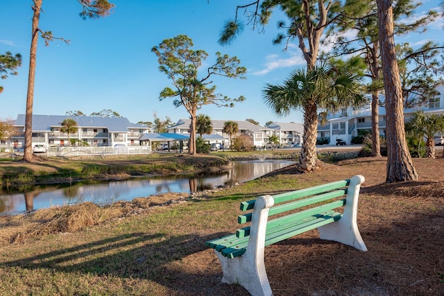 surrounding community featuring a water view