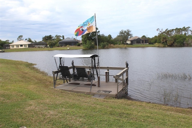 dock area featuring a water view and a lawn