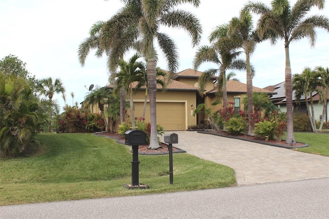 view of front of property with a garage and a front lawn