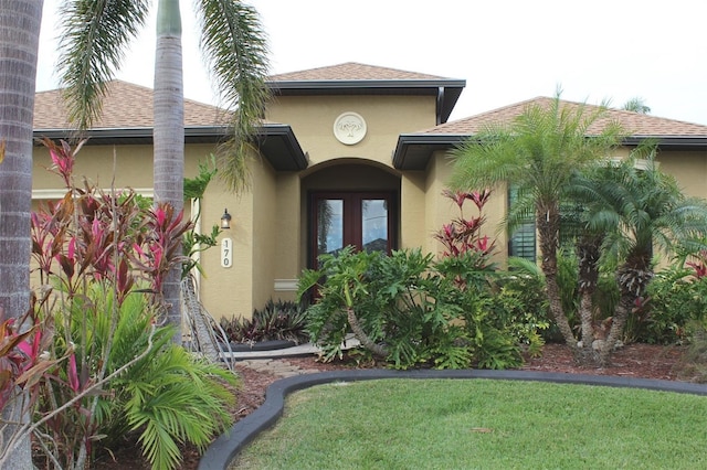 doorway to property with a yard