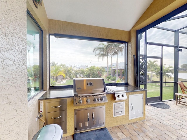 sunroom featuring lofted ceiling and plenty of natural light