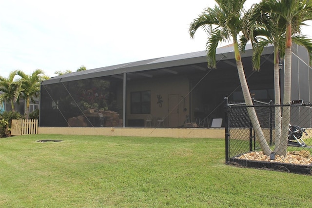 rear view of house featuring a lawn