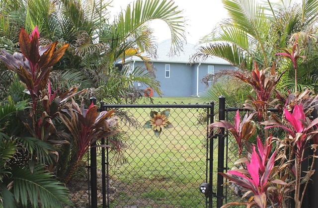 view of gate with a lawn