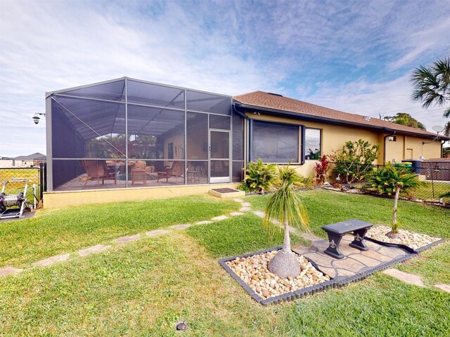 back of house featuring a yard, a lanai, and a patio area