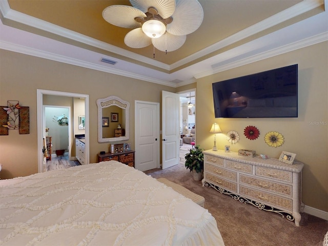 bedroom featuring a tray ceiling, crown molding, light colored carpet, and ceiling fan