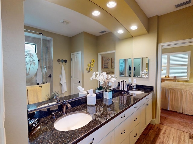 bathroom with vanity, hardwood / wood-style flooring, and walk in shower