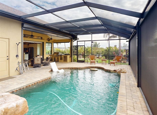 view of pool with area for grilling, a lanai, and a patio