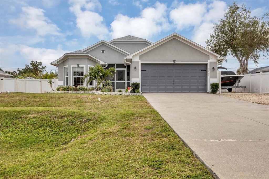 view of front of house featuring a garage and a front yard