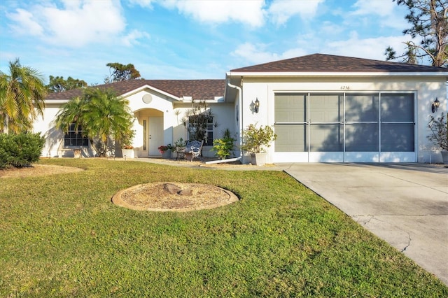 view of front of home featuring a garage and a front lawn