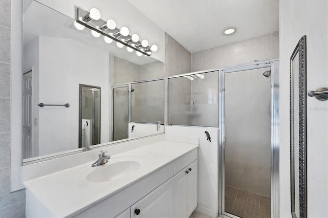 bathroom with vanity and a shower with shower door