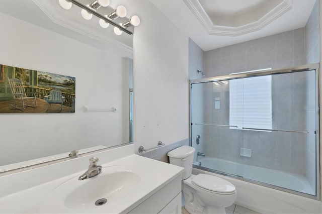 full bathroom with vanity, crown molding, toilet, enclosed tub / shower combo, and a tray ceiling