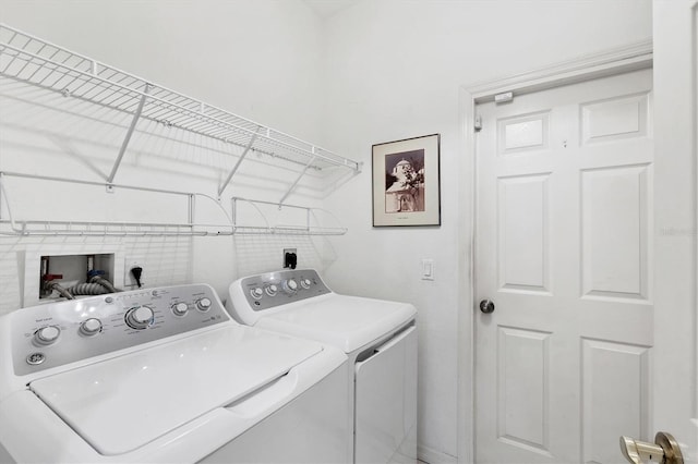 clothes washing area featuring washer and dryer