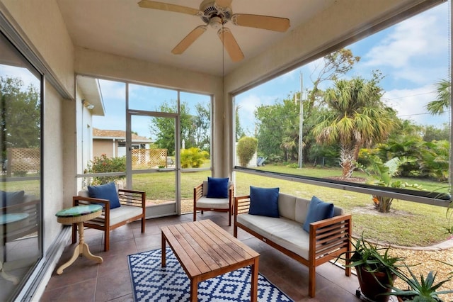 sunroom featuring ceiling fan and plenty of natural light