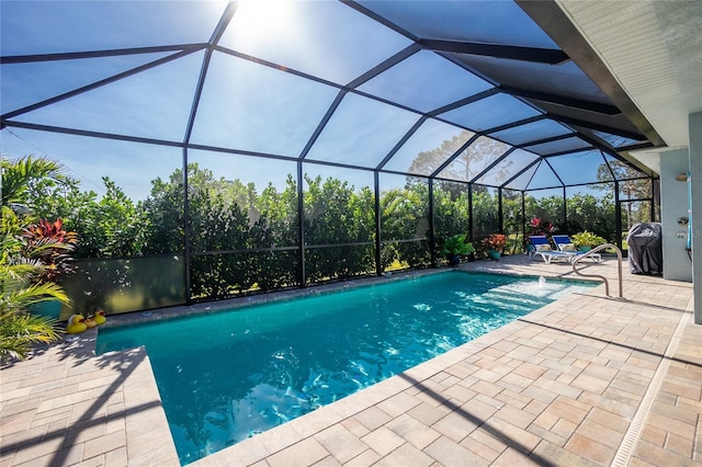 view of swimming pool with area for grilling, a lanai, and a patio