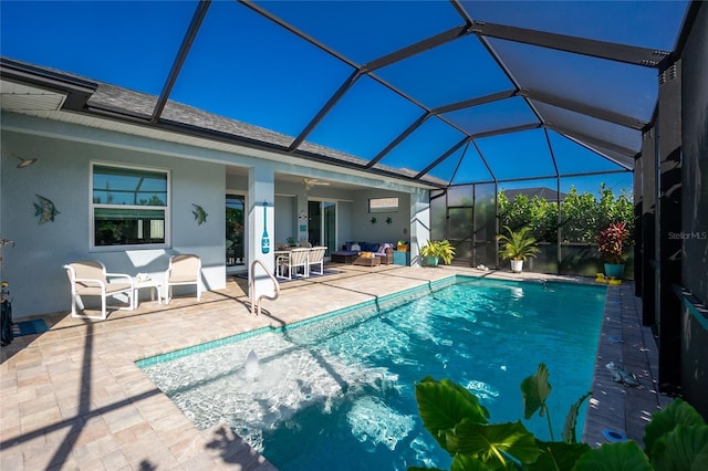 view of pool featuring outdoor lounge area, ceiling fan, a lanai, and a patio