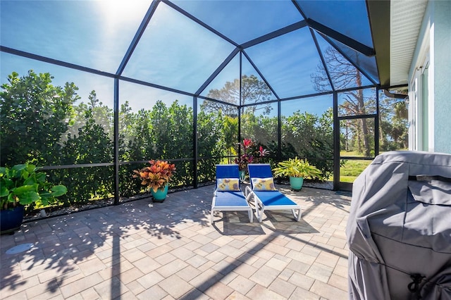 view of patio / terrace featuring glass enclosure and grilling area