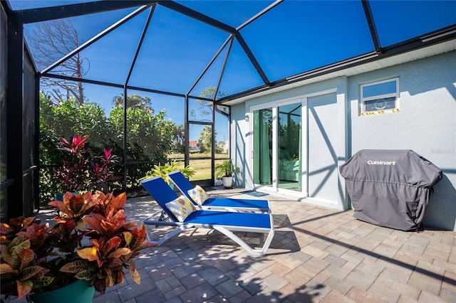 view of patio featuring a grill and a lanai