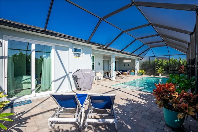 view of swimming pool featuring a patio, area for grilling, and a lanai