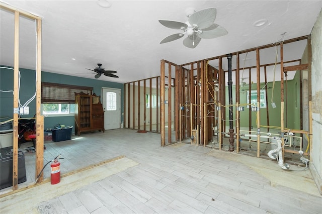 misc room with light hardwood / wood-style flooring and ceiling fan