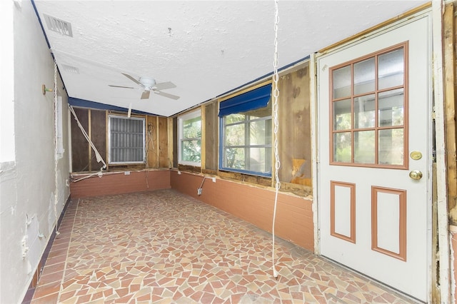 unfurnished sunroom featuring ceiling fan and lofted ceiling