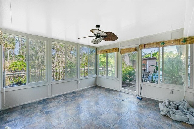 unfurnished sunroom with ceiling fan